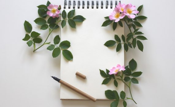 Picture of pen and notepad to represent writing letters to ourselves for self-care